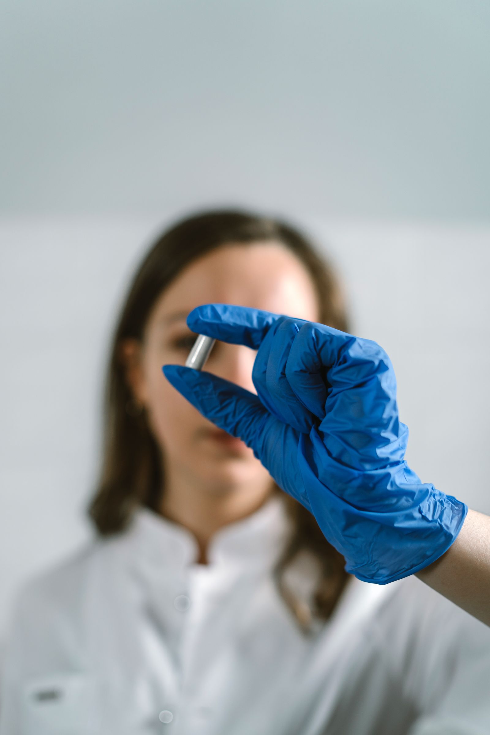 Laboratory scientist inspecting a pharmaceutical capsule