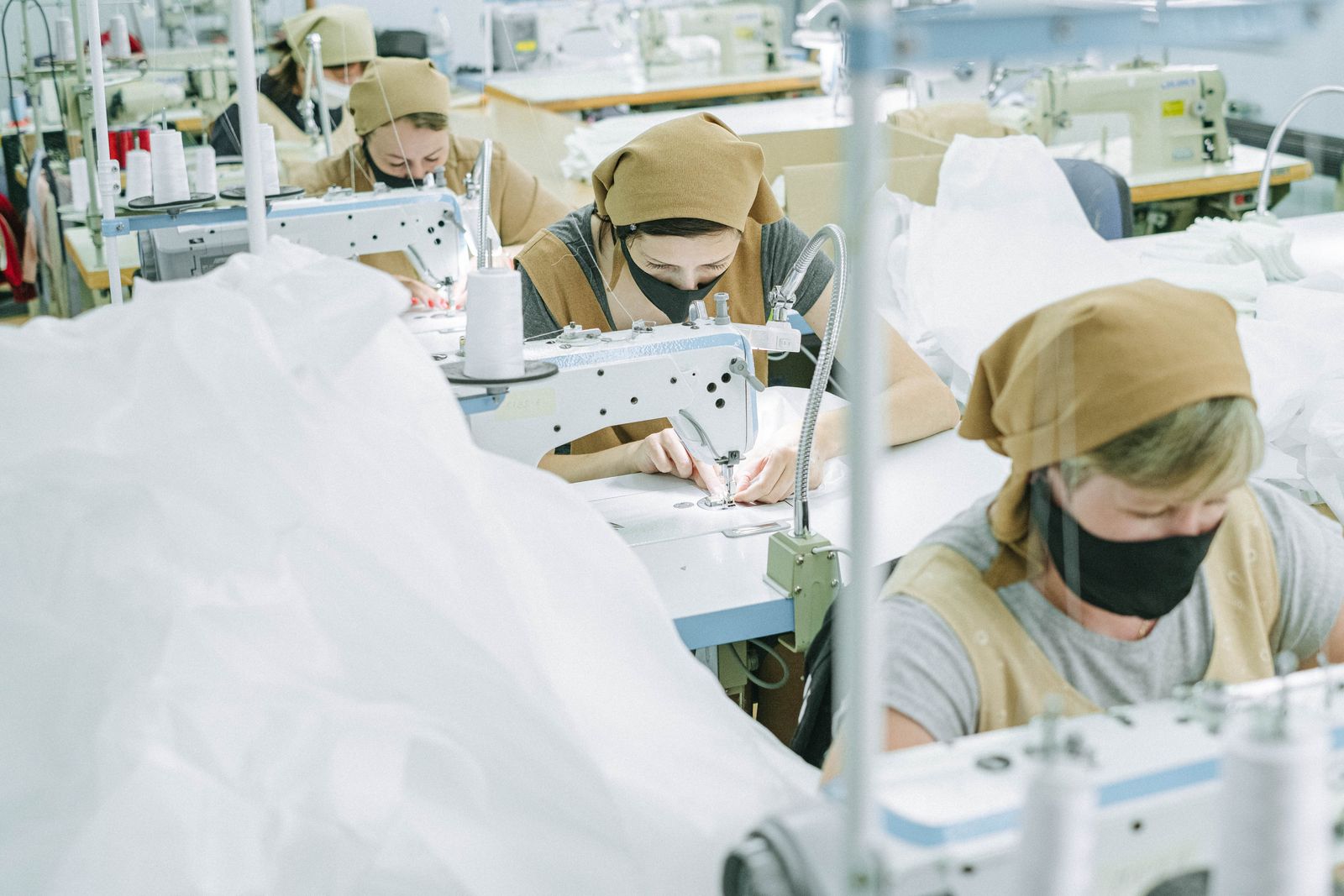 Textile workers operating sewing machines in a garment factory